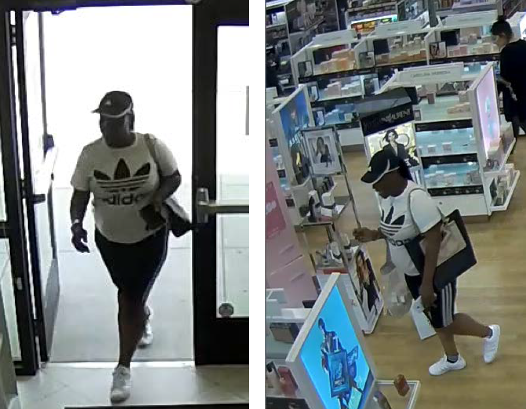 Ulta theft female suspect wearing black and white Adidas ballcap, white t-shirt with large Adidas logo, and black leggings with Adidas stripes and white shoes. Suspect is carrying a large black purse with tan detail and a white cellphone.
